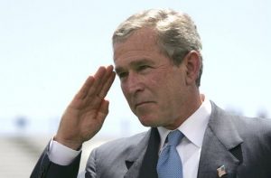 George W. Bush salutes.